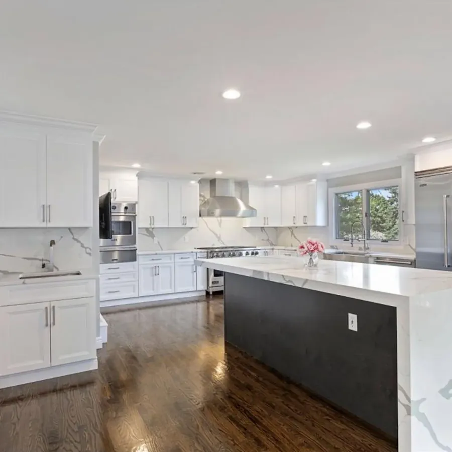 White kitchen with waterfall quartz island