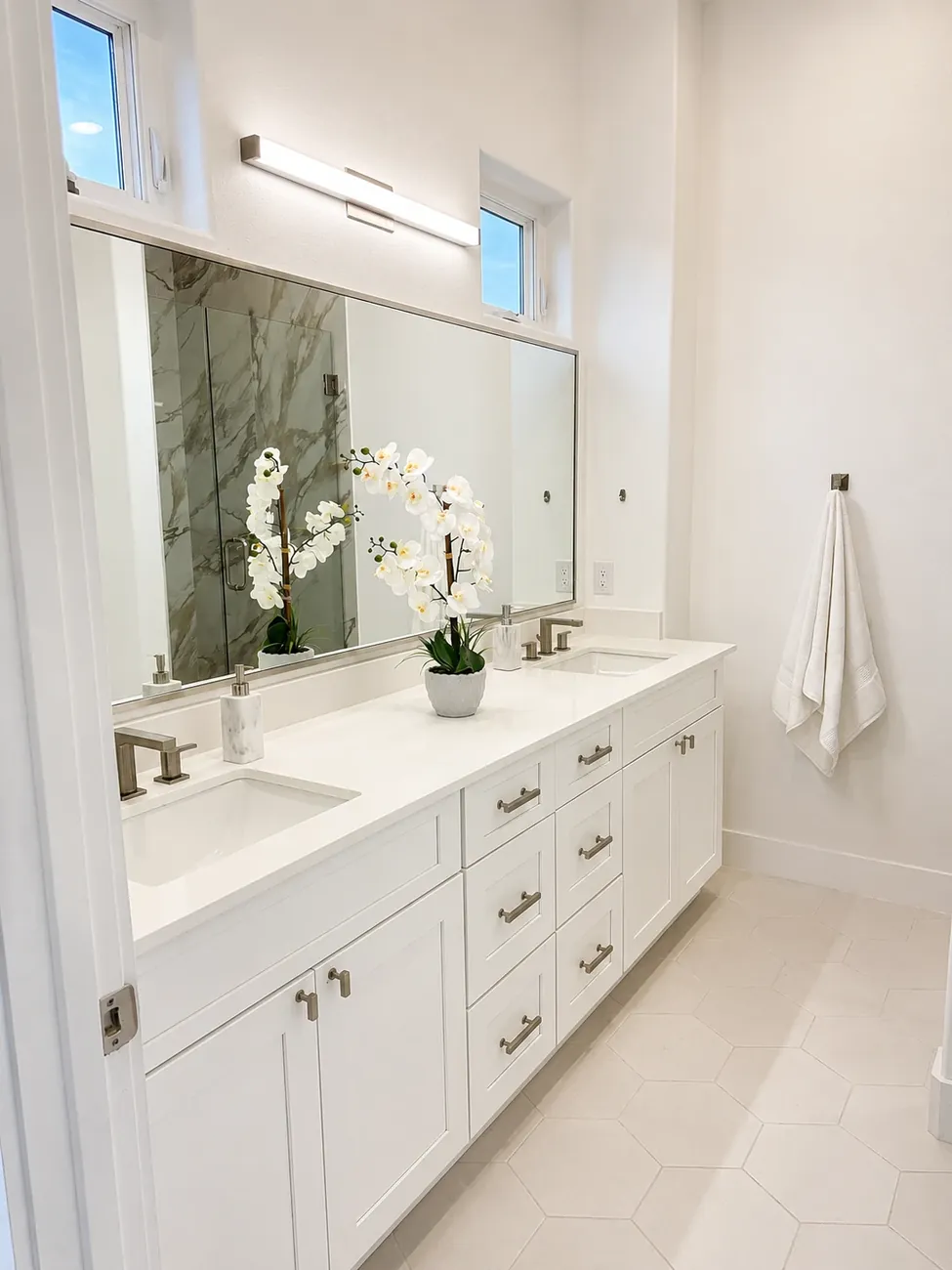 Bathroom with double vanity and hex tile floor