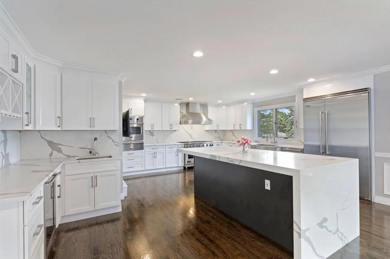White kitchen with waterfall quartz island